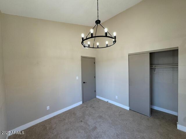 5236 W Peoria Ave Unit 232, Glendale, AZ 85302 - unfurnished bedroom featuring a chandelier, a closet, carpet floors, and high vaulted ceiling