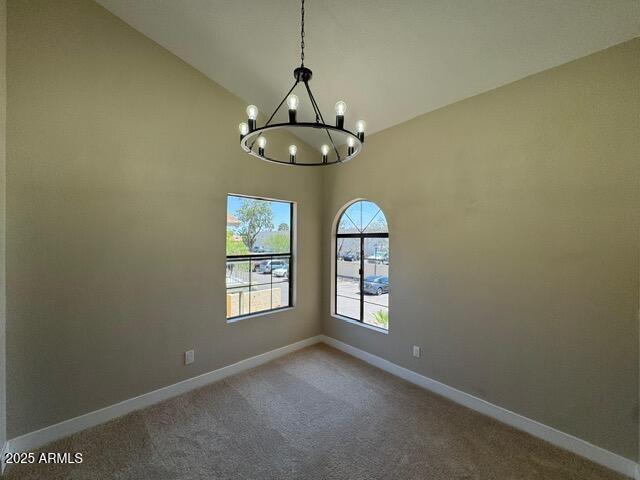 5236 W Peoria Ave Unit 232, Glendale, AZ 85302 - carpeted empty room featuring a chandelier and vaulted ceiling