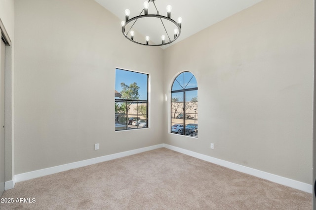 5236 W Peoria Ave Unit 232, Glendale, AZ 85302 - spare room with a chandelier, light carpet, and high vaulted ceiling