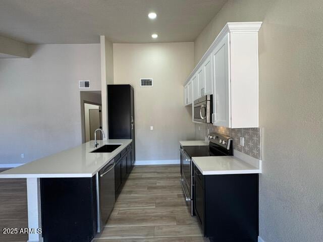 5236 W Peoria Ave Unit 232, Glendale, AZ 85302 - kitchen featuring appliances with stainless steel finishes, light countertops, a peninsula, tasteful backsplash, and recessed lighting