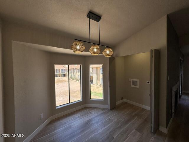 5236 W Peoria Ave Unit 232, Glendale, AZ 85302 - unfurnished dining area with wood finished floors and lofted ceiling