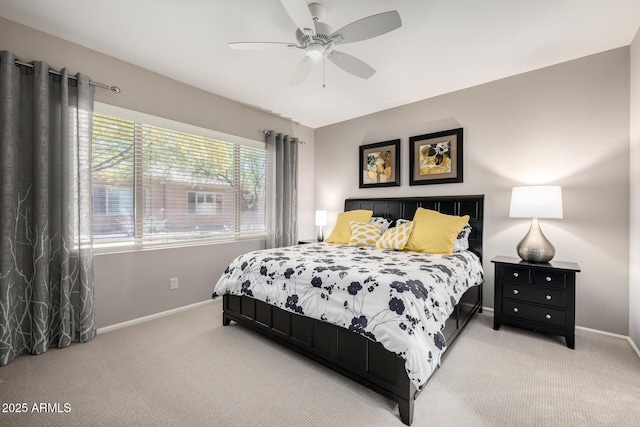carpeted bedroom with baseboards and ceiling fan