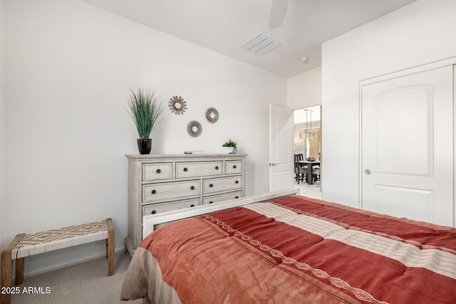 carpeted bedroom with a ceiling fan, baseboards, and visible vents