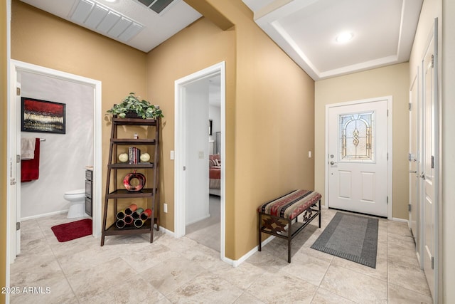 entryway with visible vents, baseboards, and light tile patterned flooring