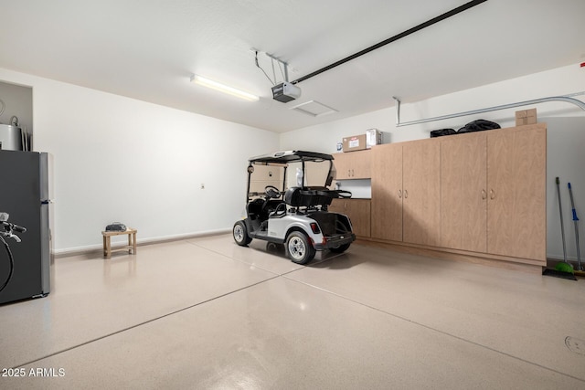 garage with a garage door opener and freestanding refrigerator