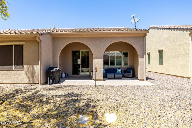 rear view of property with an outdoor hangout area, a patio, stucco siding, and a tile roof