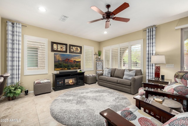 tiled living room with recessed lighting, ceiling fan, visible vents, and baseboards