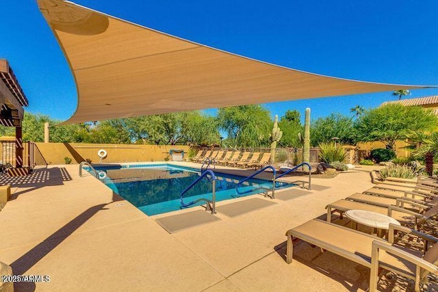 pool featuring a patio and a fenced backyard