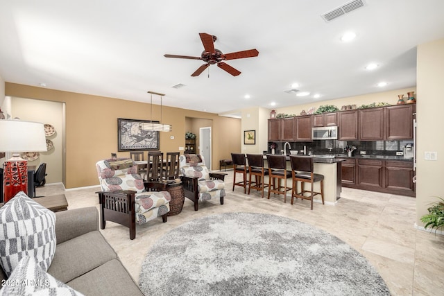 living area featuring recessed lighting, ceiling fan, and visible vents