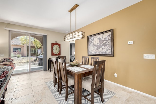 dining area featuring baseboards and light tile patterned floors