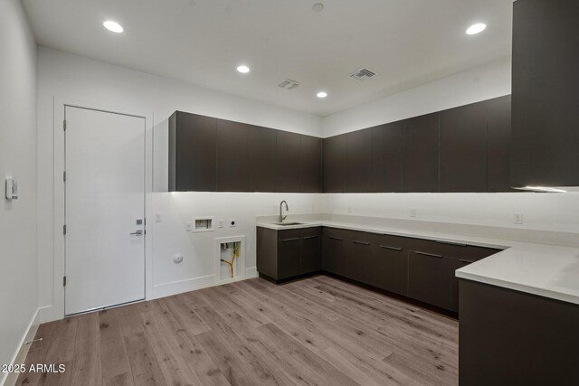 13278 E Buckskin Trl, Scottsdale, AZ 85255 - laundry room with cabinet space, washer hookup, light wood-style floors, recessed lighting, and electric dryer hookup