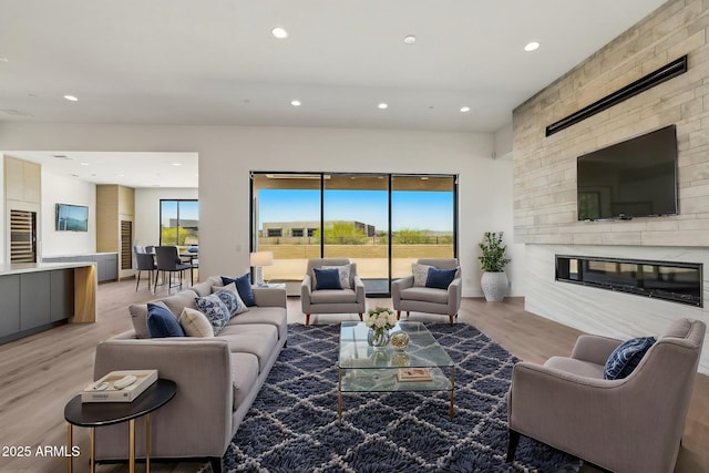 13278 E Buckskin Trl, Scottsdale, AZ 85255 - living room featuring beverage cooler, recessed lighting, light wood-style floors, and a large fireplace
