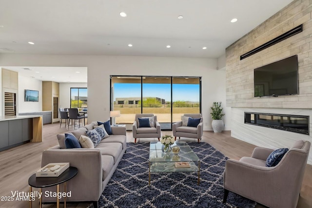 13278 E Buckskin Trl, Scottsdale, AZ 85255 - living area with recessed lighting, light wood-type flooring, wine cooler, and a large fireplace