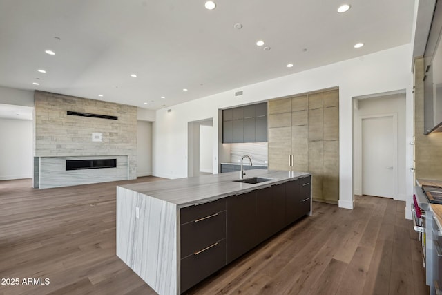 13278 E Buckskin Trl, Scottsdale, AZ 85255 - kitchen featuring modern cabinets, a sink, a large island with sink, recessed lighting, and wood finished floors
