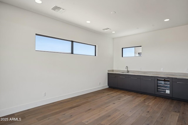 13278 E Buckskin Trl, Scottsdale, AZ 85255 - bar featuring beverage cooler, a sink, hardwood / wood-style flooring, plenty of natural light, and recessed lighting