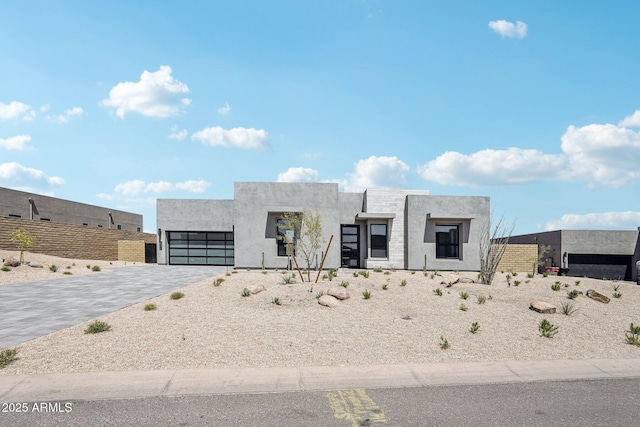 13278 E Buckskin Trl, Scottsdale, AZ 85255 - modern home featuring an attached garage, stucco siding, and decorative driveway
