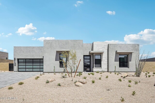 13278 E Buckskin Trl, Scottsdale, AZ 85255 - contemporary house featuring a garage, decorative driveway, and stucco siding