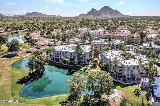 drone / aerial view featuring golf course view and a water and mountain view