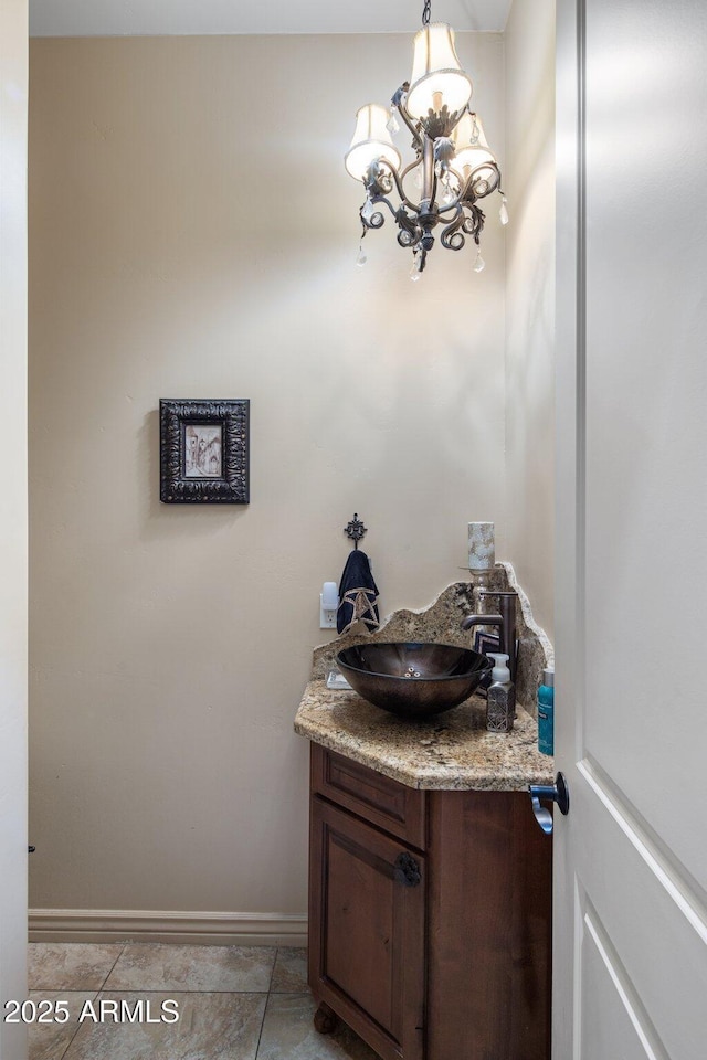 18036 W San Miguel Ave, Litchfield Park, AZ 85340 - bathroom featuring vanity, a chandelier, and baseboards