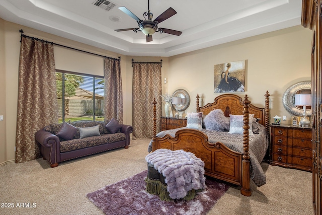 18036 W San Miguel Ave, Litchfield Park, AZ 85340 - bedroom featuring carpet flooring, a tray ceiling, and ceiling fan