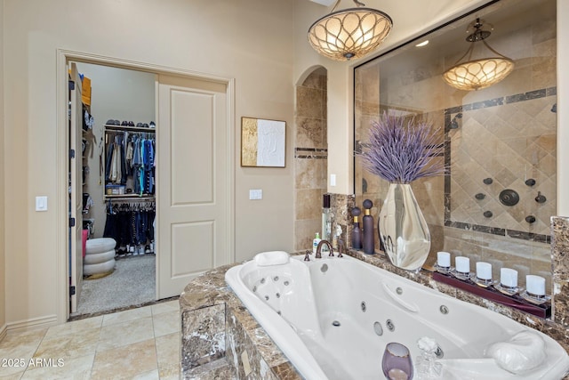 18036 W San Miguel Ave, Litchfield Park, AZ 85340 - bathroom featuring a jetted tub and a walk in closet
