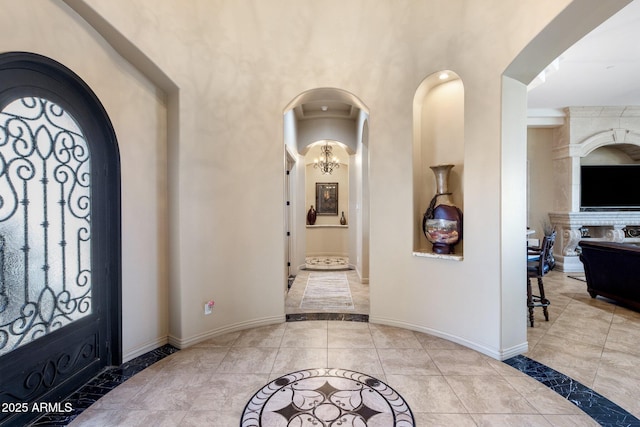 18036 W San Miguel Ave, Litchfield Park, AZ 85340 - entryway featuring inlaid floor details, baseboards, and arched walkways