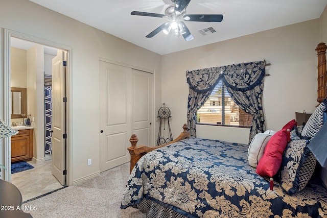 18036 W San Miguel Ave, Litchfield Park, AZ 85340 - bedroom featuring a closet, light carpet, ceiling fan, and connected bathroom