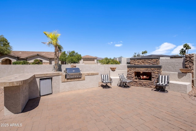 18036 W San Miguel Ave, Litchfield Park, AZ 85340 - view of patio / terrace with an outdoor stone fireplace