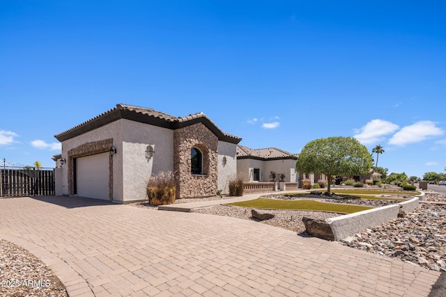 18036 W San Miguel Ave, Litchfield Park, AZ 85340 - mediterranean / spanish home with stucco siding, a tiled roof, decorative driveway, an attached garage, and stone siding