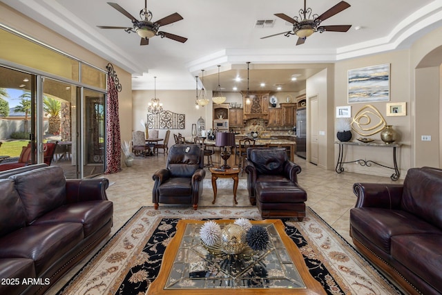 18036 W San Miguel Ave, Litchfield Park, AZ 85340 - living room featuring a ceiling fan, light tile patterned floors, a chandelier, arched walkways, and ornamental molding