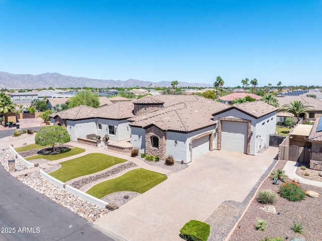 18036 W San Miguel Ave, Litchfield Park, AZ 85340 - mediterranean / spanish-style house featuring stucco siding, driveway, a garage, a tiled roof, and a residential view