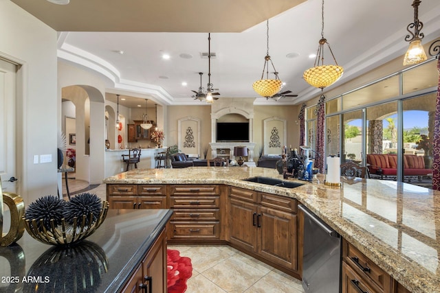 18036 W San Miguel Ave, Litchfield Park, AZ 85340 - kitchen featuring arched walkways, a sink, stainless steel dishwasher, light tile patterned floors, and pendant lighting