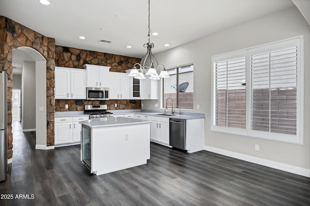 1612 E Zion Way, Chandler, AZ 85249 - kitchen with hanging light fixtures, a center island, sink, appliances with stainless steel finishes, and white cabinets