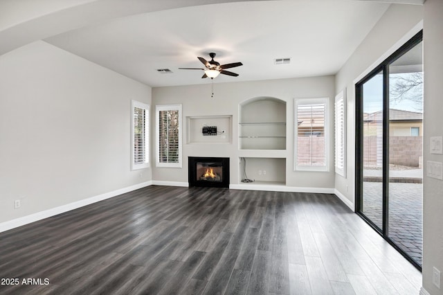 1612 E Zion Way, Chandler, AZ 85249 - unfurnished living room with ceiling fan, plenty of natural light, built in shelves, and dark hardwood / wood-style floors