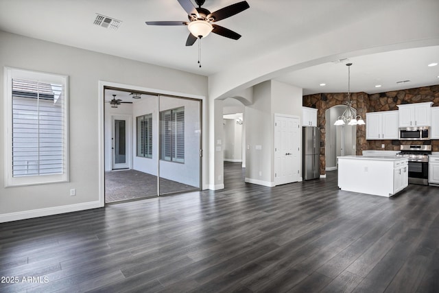 1612 E Zion Way, Chandler, AZ 85249 - unfurnished living room featuring ceiling fan with notable chandelier, dark hardwood / wood-style flooring, and a healthy amount of sunlight