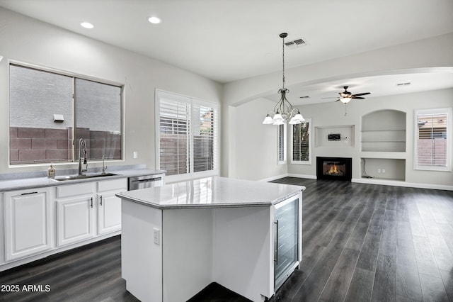 1612 E Zion Way, Chandler, AZ 85249 - kitchen with white cabinetry, decorative light fixtures, a kitchen island, sink, and dark hardwood / wood-style floors