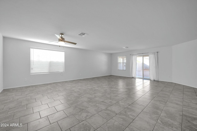 unfurnished room featuring light tile patterned flooring and ceiling fan