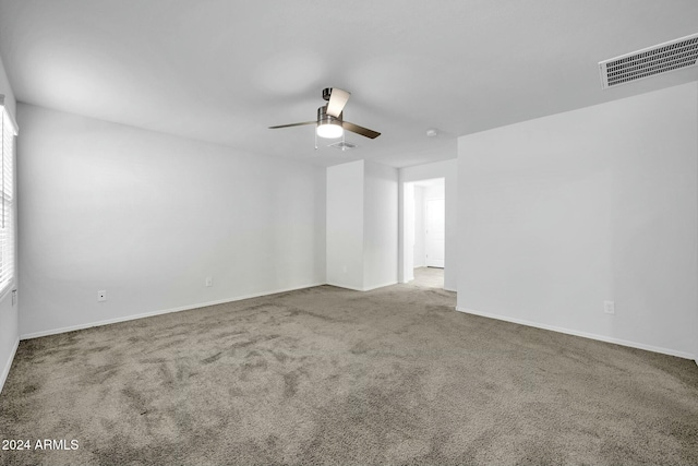 spare room with ceiling fan and carpet flooring