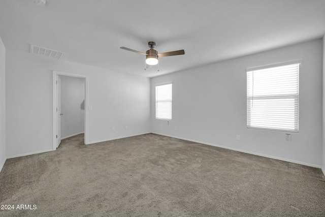 spare room with carpet floors and ceiling fan