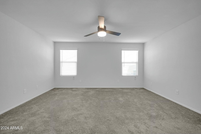 carpeted empty room with plenty of natural light and ceiling fan