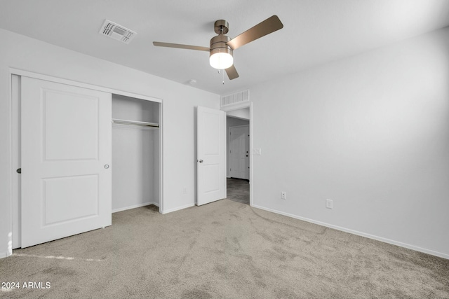 unfurnished bedroom with ceiling fan, a closet, and light carpet