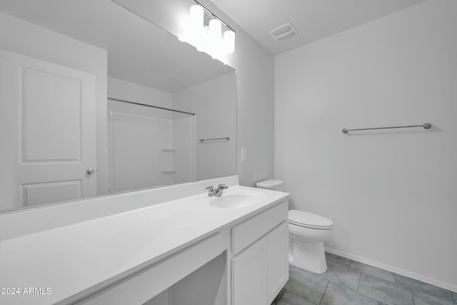 bathroom featuring vanity, tile patterned floors, toilet, and walk in shower