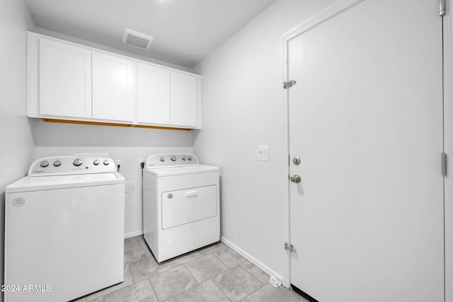 laundry area featuring cabinets and separate washer and dryer