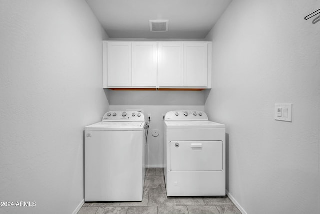 laundry area featuring cabinets and washer and clothes dryer