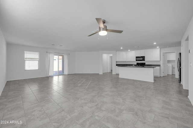 unfurnished living room featuring ceiling fan