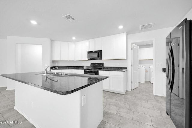 kitchen with washer and dryer, sink, a center island with sink, and black appliances