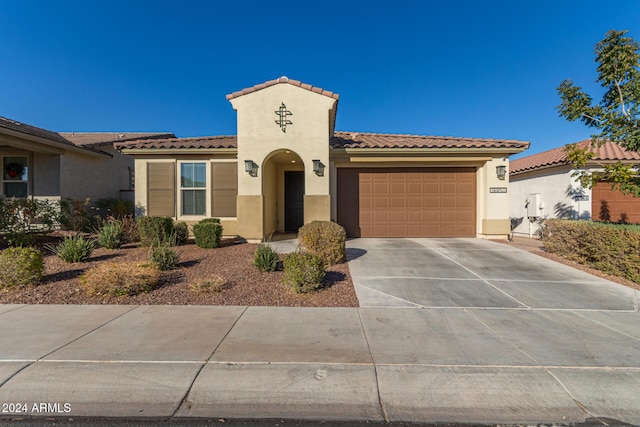 mediterranean / spanish-style home with a garage