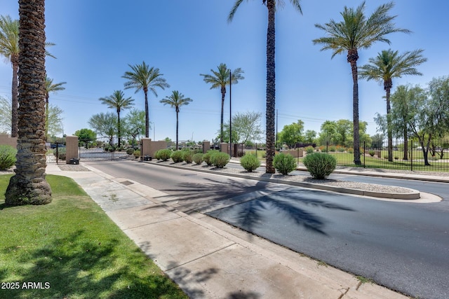 965 E Virgo Pl, Chandler, AZ 85249 - view of asphalt street featuring sidewalks, a gated entry, curbs, and a gate
