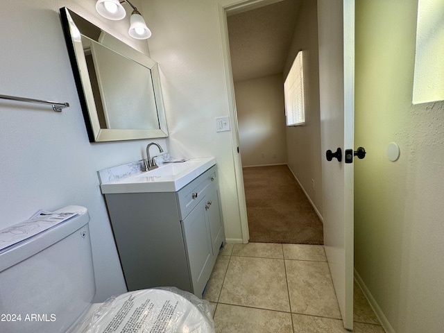 bathroom with vanity, toilet, and tile patterned floors