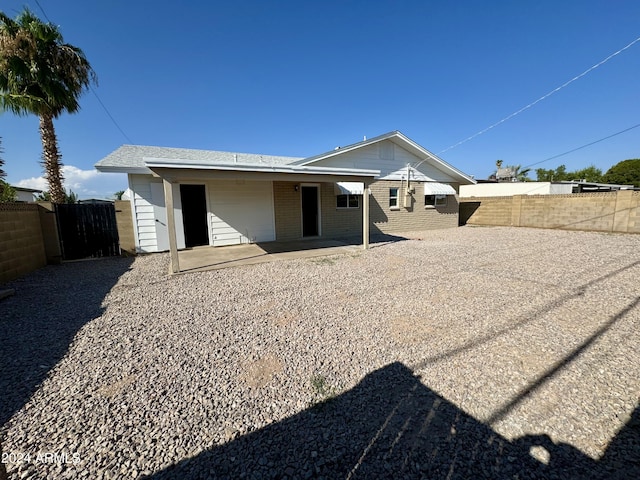 back of property with a patio